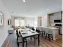 Open-concept living and dining area with hardwood floors, ample natural light, and modern decor at 329 White Tail Rd, Stockbridge, GA 30253