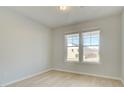 Bright bedroom featuring two windows and light colored, wood-look floors at 117 Belvedere Rd, Mcdonough, GA 30253
