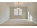 Formal dining room with elegant chandelier and natural light at 117 Belvedere Rd, Mcdonough, GA 30253