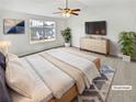 Brightly lit bedroom with a large window, neutral decor, and a ceiling fan, creating a relaxing retreat at 4969 Portsmouth Ct, Lithonia, GA 30038