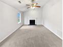 Bright living room with a fireplace and ceiling fan at 4969 Portsmouth Ct, Lithonia, GA 30038