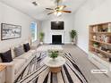 Bright living room with a fireplace, ceiling fan, and neutral decor, creating a warm and inviting atmosphere at 4969 Portsmouth Ct, Lithonia, GA 30038