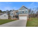 Beautiful two-story home with a blend of brick and siding, complemented by a green lawn and a spacious two-car garage at 120 Felicity Pike, Locust Grove, GA 30248