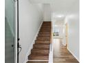 Bright entryway with wood-look flooring and a staircase leading to the upper level at 326 Oakview Way, Canton, GA 30114