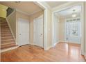 Bright entryway features hardwood floors, staircase, and natural light through the front door at 620 Willow Haven Way, Suwanee, GA 30024
