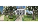Elegant home featuring a landscaped front yard, stone pathway, and classic architectural design at 1075 Lancaster Sq, Roswell, GA 30076
