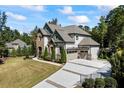 Spacious two-story home featuring a long driveway, attached two-car garage, and mature trees at 3111 Old Thompson Mill Rd, Buford, GA 30519
