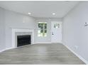 Bright living room featuring a fireplace, wood floors, and ample natural light at 5484 Denny Dr, Atlanta, GA 30349