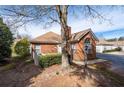 Brick exterior home with mature trees and landscaping, offering a serene living environment at 3716 Vineyards Lake Nw Cir # U-2, Kennesaw, GA 30144