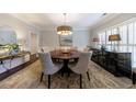 Formal dining room featuring a round table, neutral decor, and ample natural light from shuttered windows at 630 Denards Se Ml, Marietta, GA 30067