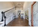Grand foyer featuring hardwood floors, a staircase, and a high ceiling with an elegant chandelier at 630 Denards Se Ml, Marietta, GA 30067