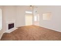 This living room features carpeted floors, a fireplace, and sliding doors leading to the outside at 6595 Browns Mill Ferry Dr, Lithonia, GA 30038