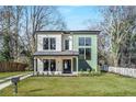 New construction home featuring modern architectural design, a well-manicured lawn, and professional landscaping at 1273 Danner Se St, Atlanta, GA 30316