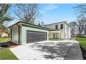 View of the home's exterior with a detached garage and modern driveway, perfect for car enthusiasts at 1273 Danner Se St, Atlanta, GA 30316
