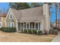 Traditional home with a well-kept lawn, inviting porch, and classic architectural details at 1474 Benjamin Sw Ct, Marietta, GA 30064