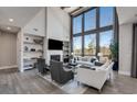 Bright living room boasts soaring ceilings, large windows, and modern decor at 13425 Bishops Ct, Roswell, GA 30075