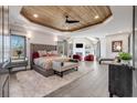 Luxurious bedroom with wood ceiling, sitting area, fireplace, and plush carpeting at 13425 Bishops Ct, Roswell, GA 30075