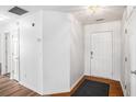 Bright entryway with neutral walls, wood-look flooring, and white doors at 2794 Hillvale Cove Way, Lithonia, GA 30058