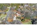 Stunning aerial view of home on a cul-de-sac featuring mature trees, a manicured lawn, and circular driveway at 5435 Heathridge Ter, Johns Creek, GA 30097