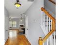 Inviting hallway with hardwood floors, showcasing access to the living spaces and staircase at 1649 Southgate Mill Dr, Duluth, GA 30096