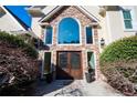 Elegant double front doors with decorative glass and stone archway at 1850 Kirkmont Nw Dr, Marietta, GA 30064