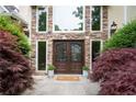 Stunning front entrance with double doors, stone accents, and decorative landscaping at 1850 Kirkmont Nw Dr, Marietta, GA 30064