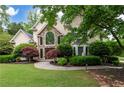 Charming two-story home with stone accents, manicured lawn and mature trees at 1850 Kirkmont Nw Dr, Marietta, GA 30064
