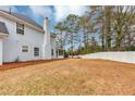 Spacious backyard with a white fence, tall trees, and well-maintained grass for outdoor enjoyment at 5705 Mountain Cres, Stone Mountain, GA 30087