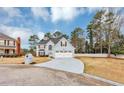 Beautiful home with well-maintained lawn, mature trees, and a long driveway leading to a two-car garage at 5705 Mountain Cres, Stone Mountain, GA 30087