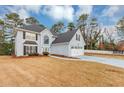 Lovely home with a spacious front yard, classic design, and a two-car garage for ample parking at 5705 Mountain Cres, Stone Mountain, GA 30087