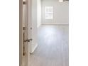 Bright bedroom featuring wood look flooring, a ceiling fan, and a window with blinds at 1010 Nandina Ct, Villa Rica, GA 30180
