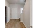 Entryway with wood-look flooring, closet, staircase, and white trim at 1010 Nandina Ct, Villa Rica, GA 30180