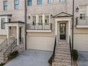 Elegant townhome showcasing classic architecture, a two-car garage, and inviting curb appeal at 3715 Peachtree Ne Rd # 9, Atlanta, GA 30319