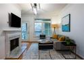 Bright living room with fireplace, sleek furnishings, and outdoor balcony access at 955 Juniper Ne St # 4229, Atlanta, GA 30309