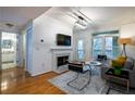 Bright living room with hardwood flooring, fireplace, and access to outdoor balcony at 955 Juniper Ne St # 4229, Atlanta, GA 30309