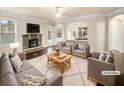Cozy living room with a stone fireplace and open access to the kitchen at 2100 Trinity Mill Dr, Dacula, GA 30019