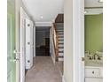Inviting foyer with tile flooring, staircase, and view into a spacious living area at 3454 Ashwood Ln, Atlanta, GA 30341