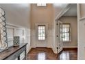 Light-filled foyer with hardwood floors and decorative wall paneling detail at 6845 Rocking Horse Ln, Cumming, GA 30040