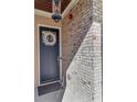 Close-up of front door and the light colored brick at 118 Via Roma, Woodstock, GA 30188