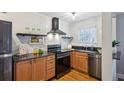 Well-appointed kitchen featuring granite countertops, stainless steel appliances, and wood cabinets with black hardware at 798 Saint Charles Ne Ave # 5, Atlanta, GA 30306