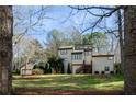 Exterior showcasing a multi-car garage, large front lawn, and well-maintained landscaping around a traditionally designed home at 150 Karina Pl, Canton, GA 30115