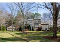 A charming home featuring a multi-car garage, manicured lawn and landscaping, and a traditional exterior design at 150 Karina Pl, Canton, GA 30115