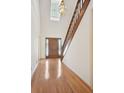 Bright foyer with hardwood floors, paneled entry door with sidelights, and staircase with wood banister at 11710 Mountain Laurel Dr, Roswell, GA 30075