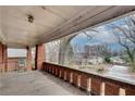 Covered brick porch with brick guard rail showcasing the neighborhood and mature trees at 1523 Melrose Sw Dr, Atlanta, GA 30310