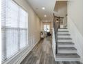Open entryway showcasing staircase, laminate floors, and natural light from large windows at 3606 Elkhorn Nw Ct, Duluth, GA 30096