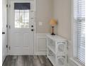 Bright entryway with stylish laminate flooring, white trim, and a view of the front door at 3606 Elkhorn Nw Ct, Duluth, GA 30096