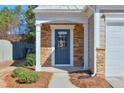 Inviting front entryway with a blue door, stone accents, and well-maintained landscaping at 3606 Elkhorn Nw Ct, Duluth, GA 30096