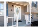 Close-up of the front porch with a white railing and decorative front door at 975 Malibu Dr, Marietta, GA 30066