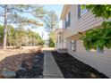 A side view of the house with a concrete pathway and landscaped garden at 975 Malibu Dr, Marietta, GA 30066