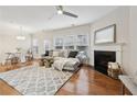 Bright living room features hardwood floors, a fireplace, and modern decor with ample natural light at 220 Ashley Se Ln # 19, Smyrna, GA 30080